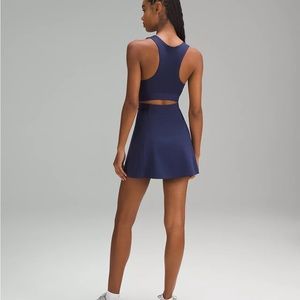 Dark blue tennis dress with built-in support. Never worn, tags still on.